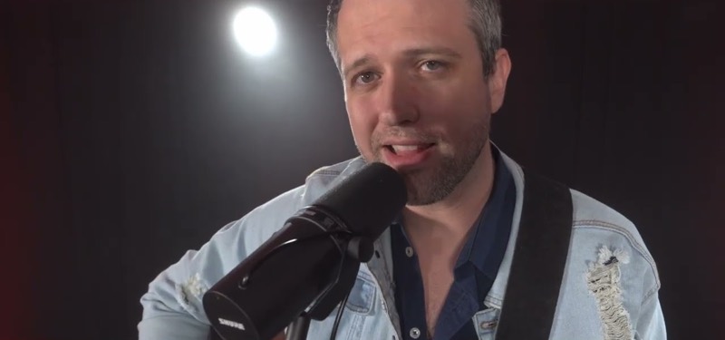 A singer under a single spotlight
