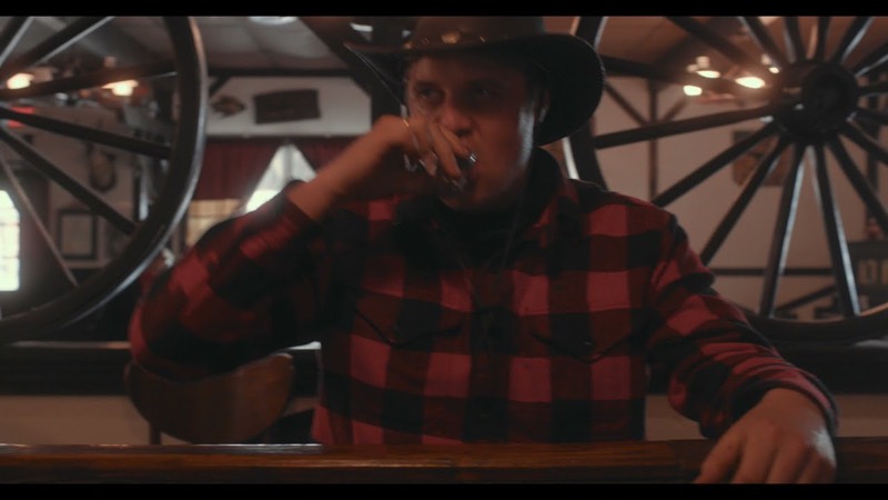 A Western-costumed cast on a saloon set